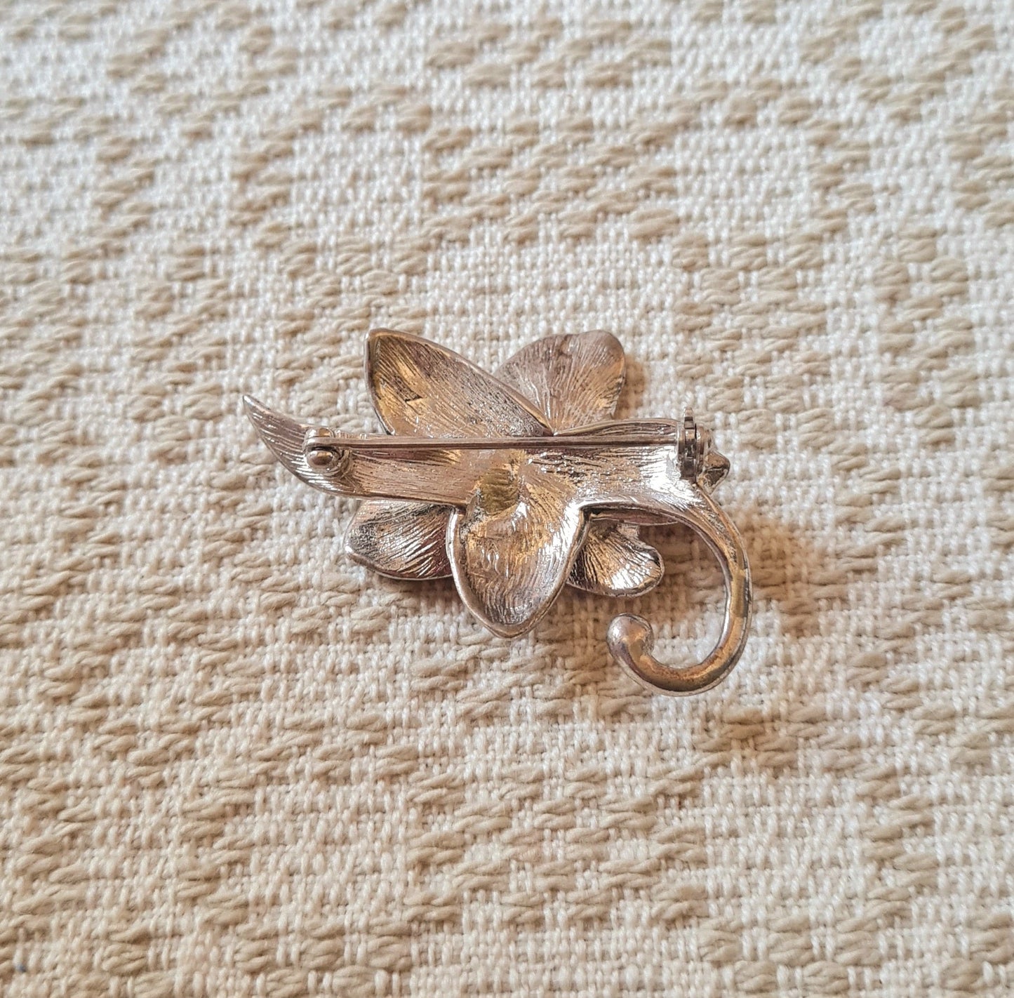 Spilla a forma di fiore con petali bordeaux, montatura argento.